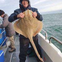 Peter Gill with a big blonde ray caught on Poole based boat Silver Spray